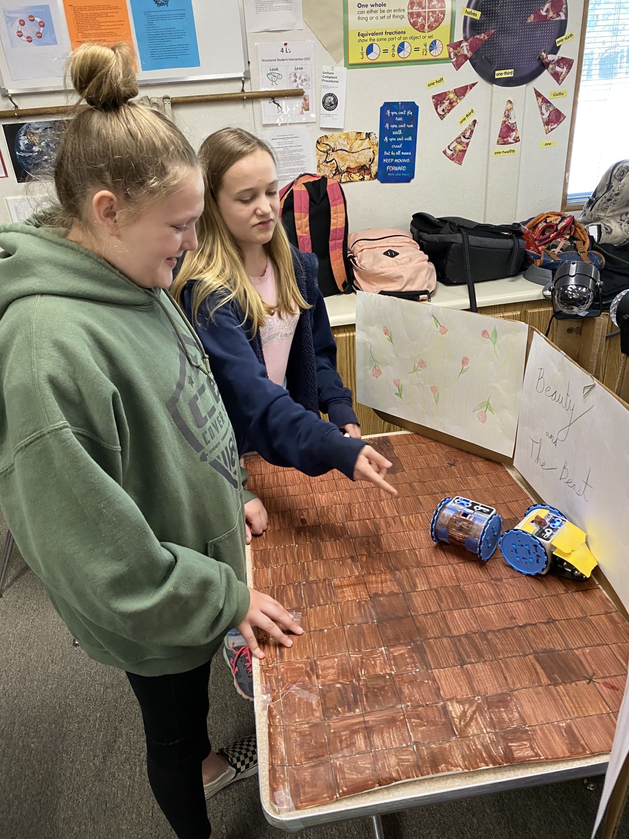 4. (left to right) Isabella Messier and Leah Arnold discuss the moves they want their robots to do..jpg